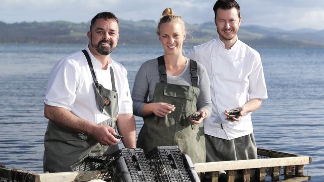 TAS WEEKEND: Harvest shoot: Blackman Bay Oyster Farm co-owner, Isabelle Clarkson (centre) with Hobart restaurant, Aloft chefs, Glenn Brynes (centre) and Christian Ryan at Blackman Bay PICTURE: Luke Bowden