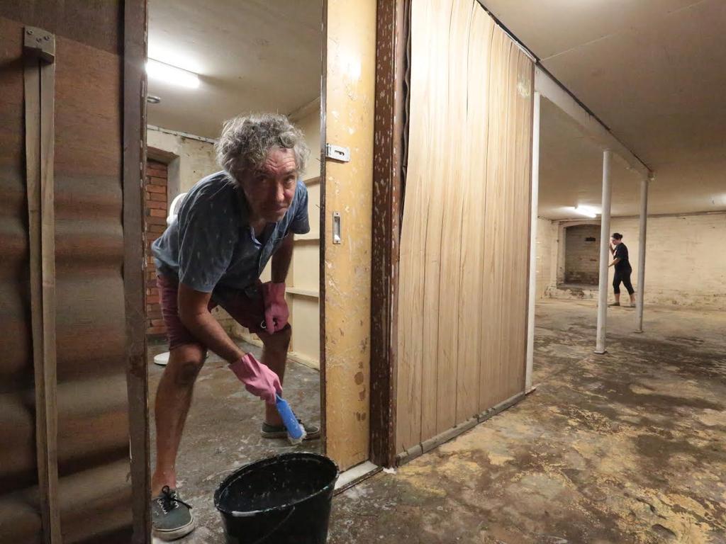 Kent St business owners Austin Brixton and Ann Cleary are still cleaning up after January’s flood, which inundated their business. Photo: Robyne Cuerel