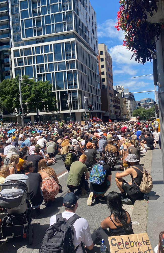 A moment of silence on busy Elizabeth Street during Sydney's Invasion Day rally. Picture: Brooke Rolfe