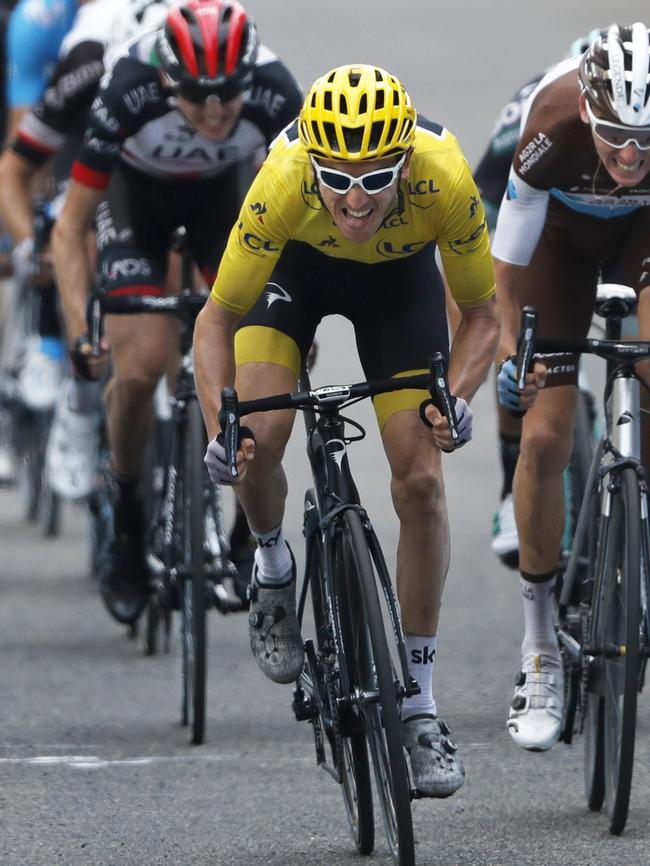 Geraint Thomas grimaces as he sprints with France's Romain Bardet, right, and Ireland's Daniel Martin on the 19th stage. Picture: AP Photo/Peter Dejong