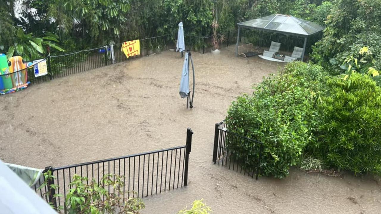 Bluewater Creek starts to flow through backyards. Kristy Waugh's pool is completely hidden by creek water. Sunday (Feb 2)