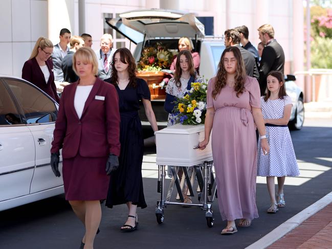 Lydia Drozd’s coffin is accompanied by pallbearers, including her sisters, as they leave the funeral. Picture: Damian Shaw