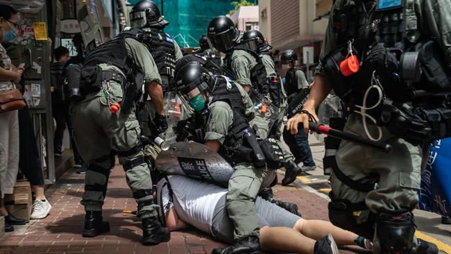 A man is detained by riot police in Hong Kong on Tuesday. Picture: Getty Images