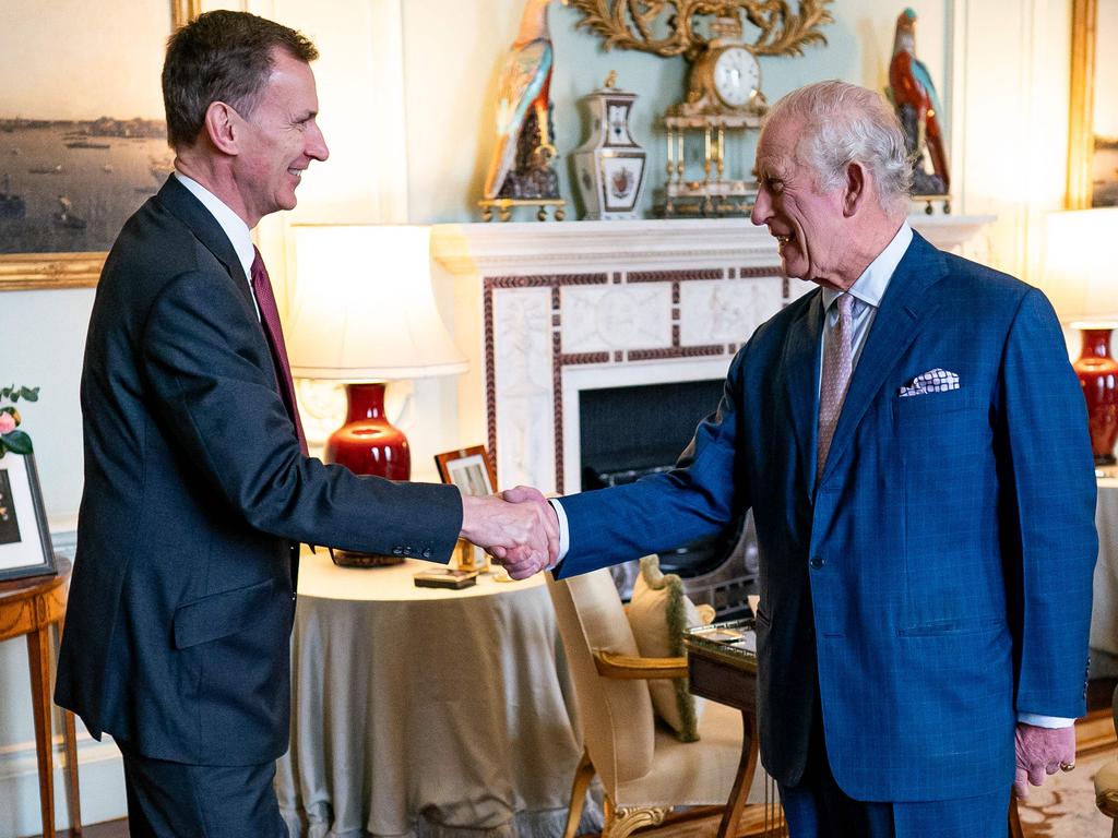 King Charles shakes hands with Britain’s Chancellor of the Exchequer, Jeremy Hunt, in the private audience room at Buckingham Palace. Picture: AFP