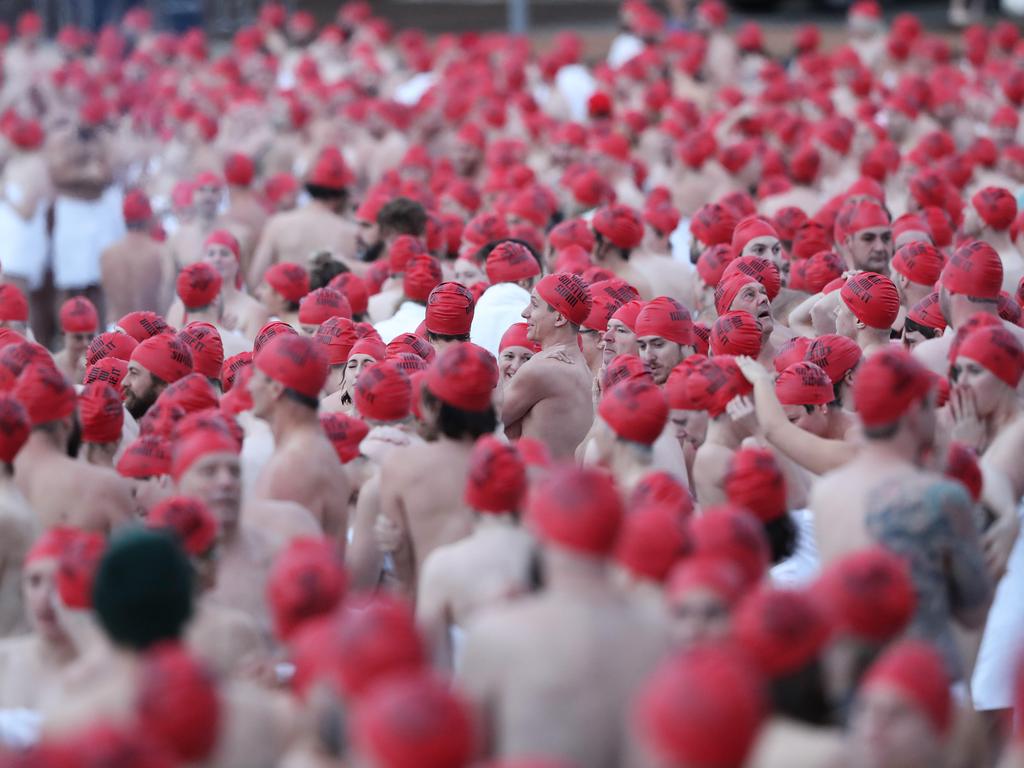 DARK MOFO 2019: Participants of the nude solstice swim brave the cold water at dawn at Long Beach, Sandy Bay. Picture: LUKE BOWDEN