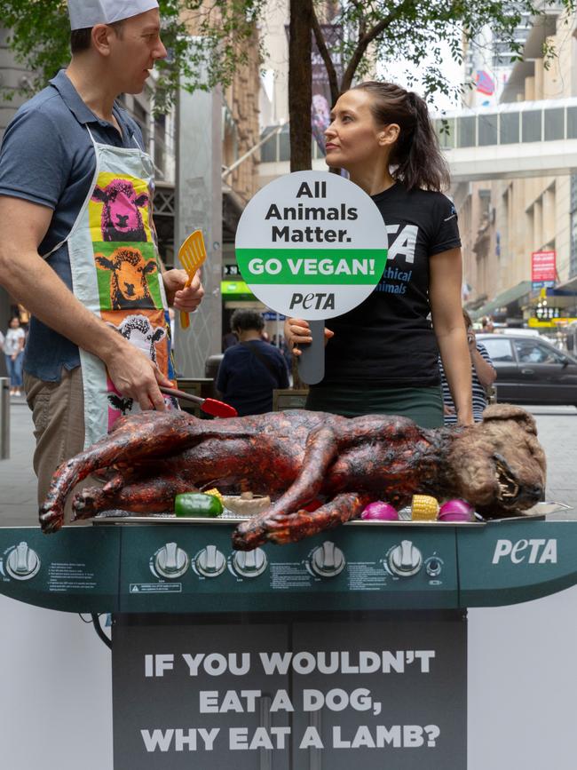 Emily Rice pretending to barbecue a fake dog during a PETA protest at Sydney’s Pitt Street Mall. Picture: PETA