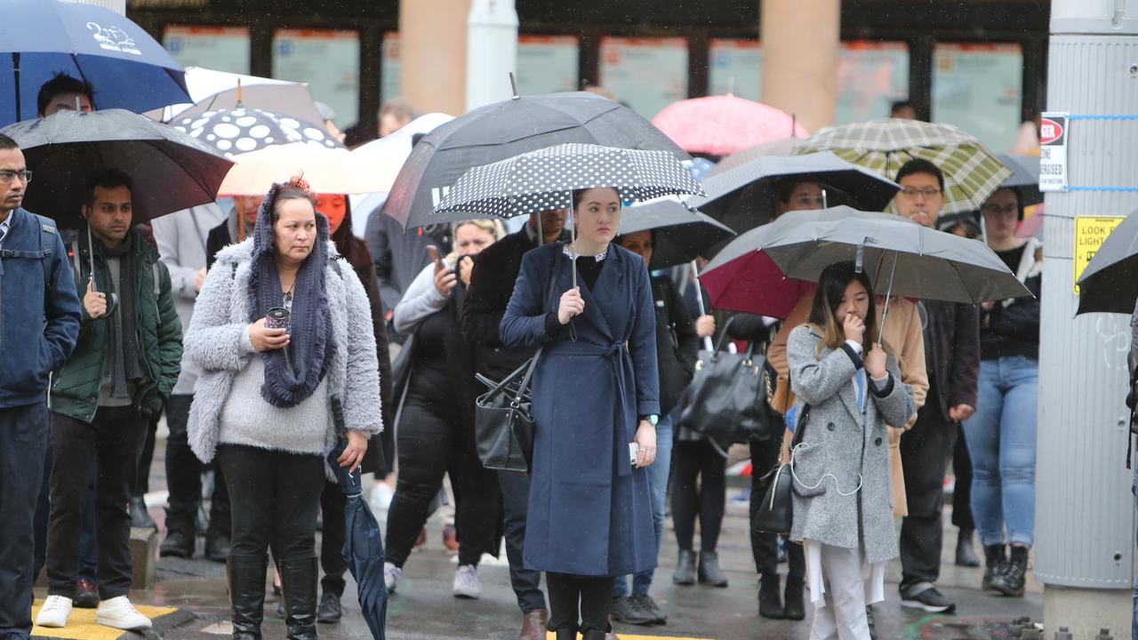 It’s a battle of the brollies outside. Picture: Tim Hunter