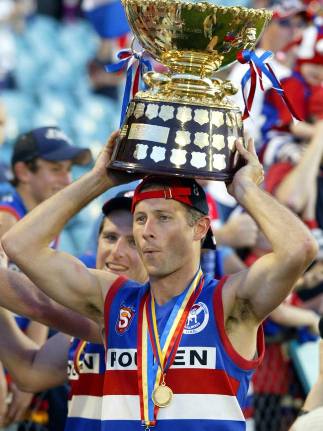 Luke McCabe holds the 2005 SANFL premiership cup aloft after Central District beat the Eagles by 28 points. Picture: File