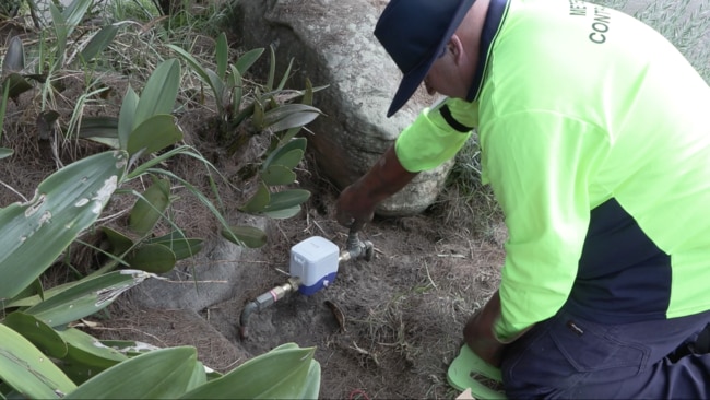 A Sydney Water contractor installing a smart meter at a residential property. Photo: Sydney Water