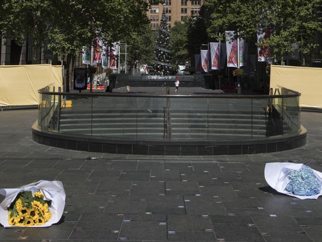 Two bunches of flowers lay on the ground at the site of a permanent memorial honouring the lives of Tori Johnson and Katrina Dawson at Martin Place. Picture: Jessica Hromas/Getty Images