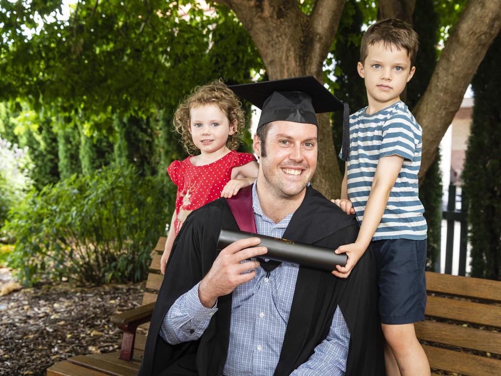 Bachelor of Spatial Science Technology (Surveying) (Honours) graduate Lewis Sweet with his kids Matilda and Arthur Sweet at the UniSQ graduation ceremony at Empire Theatres, Tuesday, December 13, 2022. Picture: Kevin Farmer