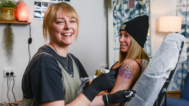 SA's best tattoo artist Caitlin Thomas, left, with client Sam O’Connell at Banksia Studio. Picture: Brenton Edwards