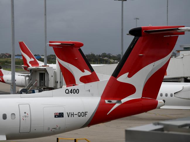 SYDNEY, AUSTRALIA - NCA NewsWire Photos DECEMBER, 31, 2020: The tails of grounded Qantas planes are seen on the tarmac at Sydney Domestic Airport. Victoria has announced a hard border closure with NSW from 11:59pm on January 1, whilst SA will reimpose its hard border closure with NSW from midnight January 1, following 10 new COVID-19 cases in NSW today. Picture: NCA NewsWire/Bianca De Marchi