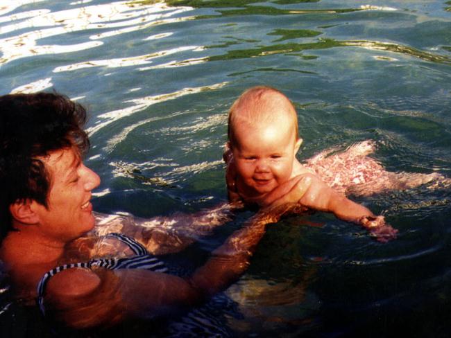 Kathleen Folbigg swimming with daughter Laura whose death, a new petition attests, should not be ruled as homicide.