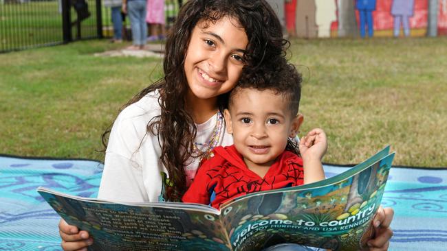 Amy Gomez reads to her brother Johnny Gomez at the Stay and Play NAIDOC week celebration. Picture: Shae Beplate.