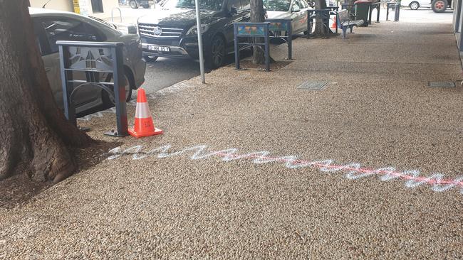 Spray paint denotes a large crack in the path on Albion Rd, Albion. Picture: Thomas Morgan.