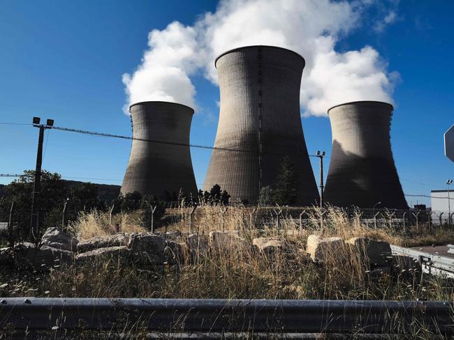 (FILES) Steam rises from the cooling towers of the Bugey nuclear power plant in Saint-Vulbas, central France, on July 20,2023. There will be new debates on nuclear safety reform on March 11, 2024 in the National Assembly, where the government will try to restore a key article of its controversial merger project between , Nuclear Safety Authority (ASN) and IRSN, the Institute of Radiation Protection and Nuclear Safety. (Photo by OLIVIER CHASSIGNOLE / AFP)