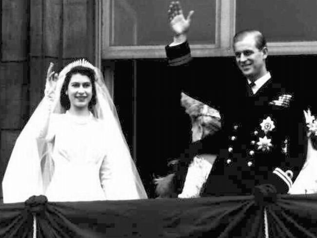 Princess Elizabeth and husband Prince Philip wave from balcony of Buckingham Palace, following their wedding earlier in the day at Westminster Abbey in London in 1947.