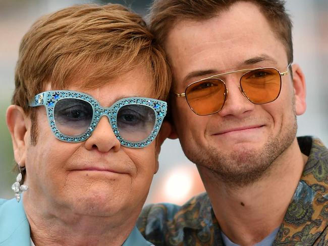 TOPSHOT - British singer-songwriter Elton John (L) and British actor Taron Egerton pose during a photocall for the film "Rocketman" at the 72nd edition of the Cannes Film Festival in Cannes, southern France, on May 16, 2019. (Photo by Alberto PIZZOLI / AFP)