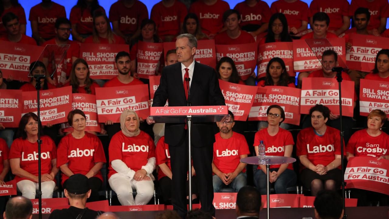 Bill Shorten speaks at a volunteers rally in front of red Labor banners, in the style of American campaigning. Picture: Kym Smith