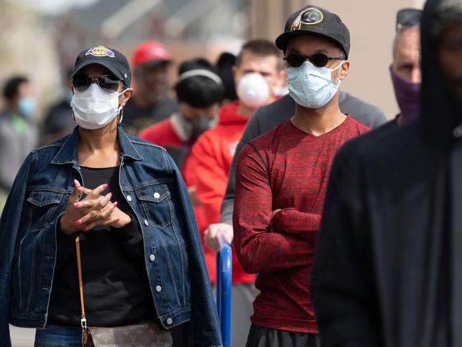 Shoppers wear masks as they wait in line to get into Lowes Home and Garden Centre in Washington, DC. Picture: AFP