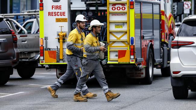 Ergon Energy workers respond to an electricity outage on Grafton Street in the city CBD, while Queensland Fire and Emergency Services firefighters attended to government workers at the Cairns Commonwealth Centre who were stuck in a lift due to the power outage. Picture: Brendan Radke