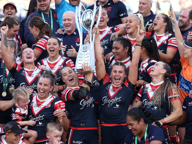 SYDNEY, AUSTRALIA - OCTOBER 06:  Isabelle Kelly and Jessica Sergis of Roosters pose with the NRL Women's Premiership Trophy after winning the NRLW Grand Final match between Sydney Roosters and Cronulla Sharks at Accor Stadium on October 06, 2024, in Sydney, Australia. (Photo by Cameron Spencer/Getty Images)