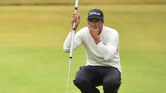 Australia's Adam Scott lines up a putt on the 18th green.