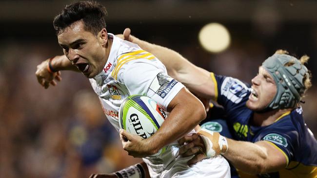 James Lowe of the Chiefs evades the tackle of David Pocock of the Brumbies to score a try.