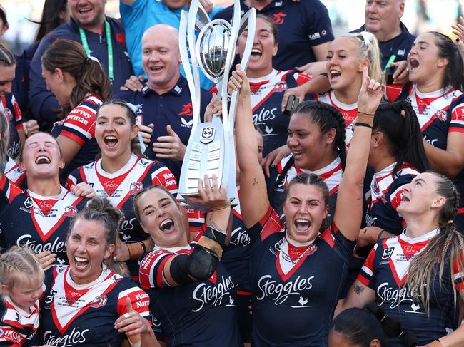 SYDNEY, AUSTRALIA - OCTOBER 06:  Isabelle Kelly and Jessica Sergis of Roosters pose with the NRL Women's Premiership Trophy after winning the NRLW Grand Final match between Sydney Roosters and Cronulla Sharks at Accor Stadium on October 06, 2024, in Sydney, Australia. (Photo by Cameron Spencer/Getty Images)