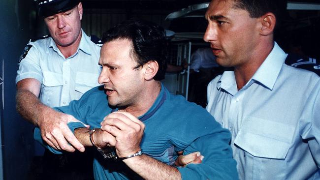 Bombing suspect Domenic Perre being taken into court after his arrest in 1996.