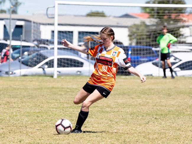 Claire Larden clearing the ball from defence