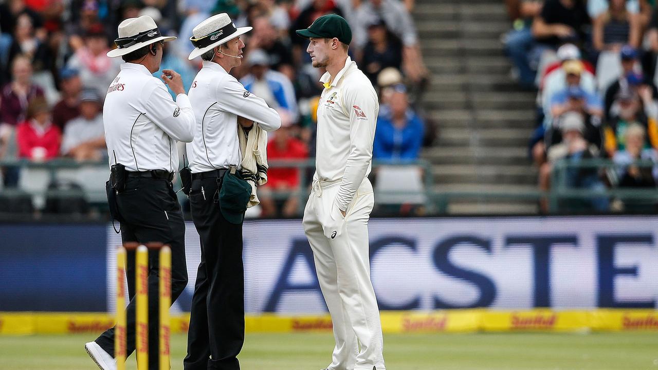 Australia’s Cameron Bancroft (R) is questioned by umpires Richard Illingworth and Nigel Llong during the famous Cape Town Test. Picture: AFP