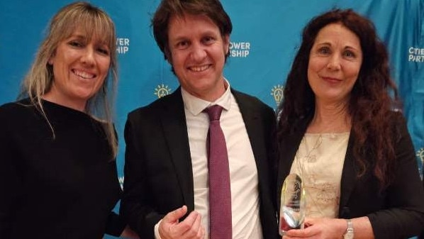 Tweed Mayor Chris Cherry (right) is congratulated by broadcaster and environmental advocate Craig Reucassel. They are pictured with Tweed Shire Council director sustainable communities and environment Naomi Searle at the State Library in Melbourne.