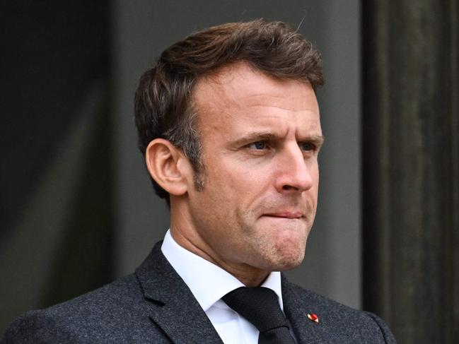 French President Emmanuel Macron waits to welcome Ghanaian President during a meeting at the Elysee Palace in Paris on October 13, 2022. (Photo by Emmanuel DUNAND / AFP)