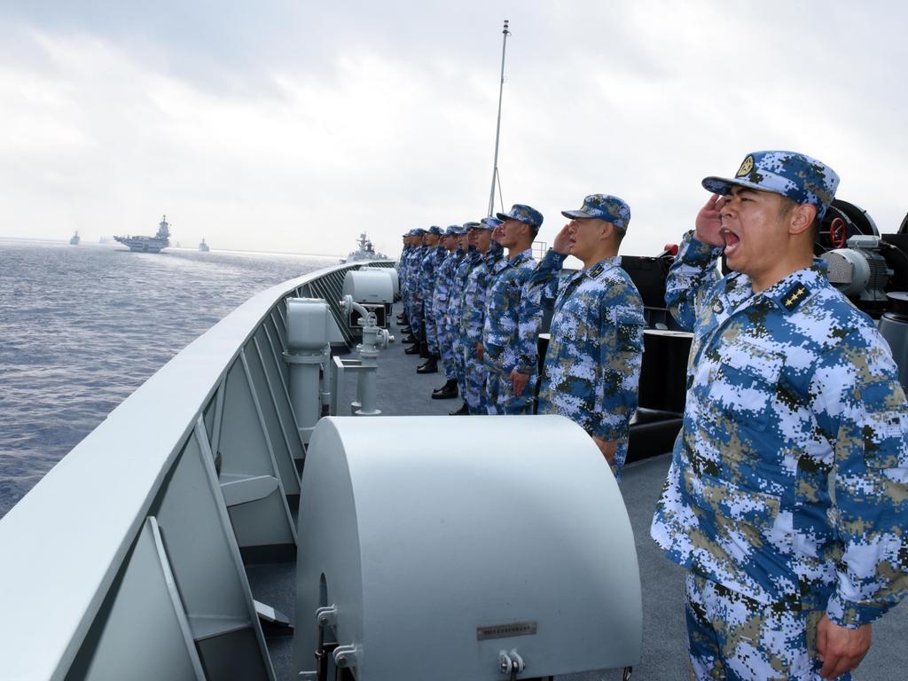 A PLA Navy fleet including the aircraft carrier Liaoning, submarines, vessels and fighter jets take part in a review in the South China Sea. Picture: Getty