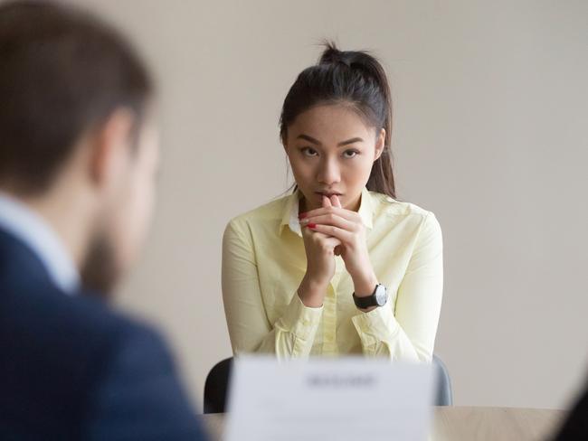 GCB PICTURE - Nervous young Asian job applicant wait for recruiters question during interview in office, worried intern or trainee feel stressed applying for open position, meeting with hr managers. Hiring concept