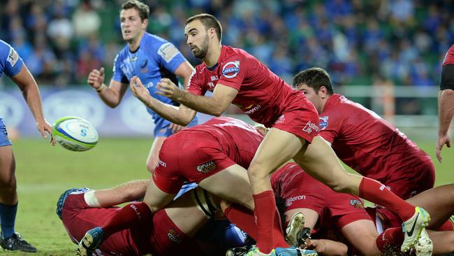 Reds scrumhalf Nick Frisby gets a pass away during Queensland’s match against the Western Force.