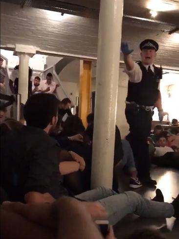 Police enter the Katzenjammers bar near London's Borough Markets and order patrons to the floor after a number of terrorists with knives enter the area. Source: James Yates @Yatesy17