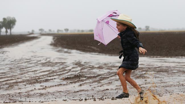 Grace Groves, 7, rejoices in the rain on her family farm near Gunnedah in drought-ravaged northwest NSW. Picture: Peter Lorimer