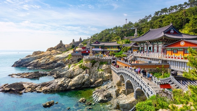 <h2><span>7. Find zen at the Haedong Yonggunsa Temple</span></h2><p><span>There are fewer more beautiful temples on the planet. <a href="http://yongkungsa.or.kr/">This</a> Buddhist sanctuary was built into the cliff face in 1376 and it is bordered by mountains on one side and ocean on the other. It’s littered with statues, bridges, the 108 stairs of longevity and even a mineral spring that promises blessings to those who drink of its water.</span></p>