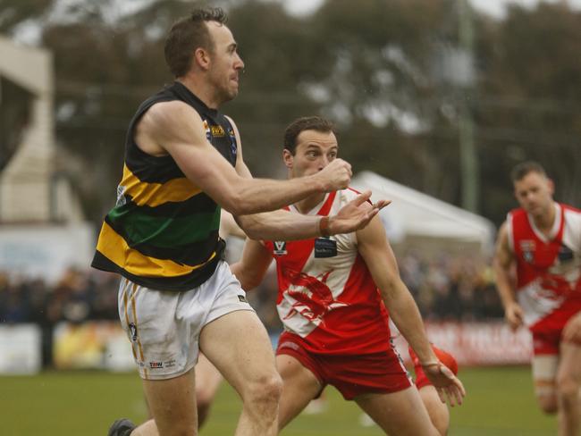 Dromana’s Beau Cosson fires out a handball in last season’s MPNFL Division 1 grand final. Picture: Valeriu Campan