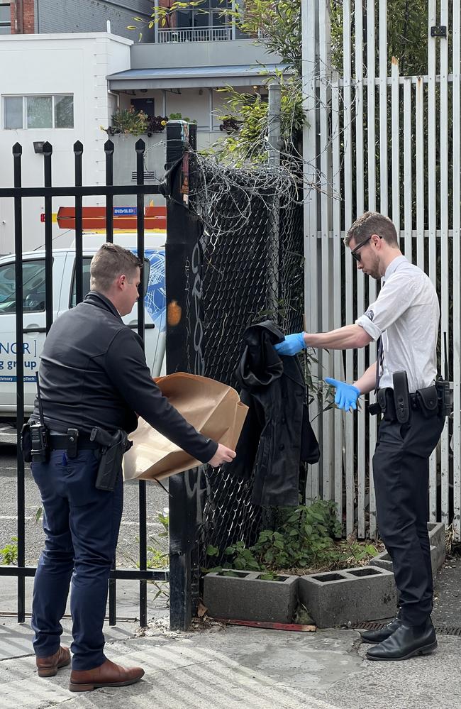 A jacket found at the scene is collected by detectives. Picture: Fergus Ellis