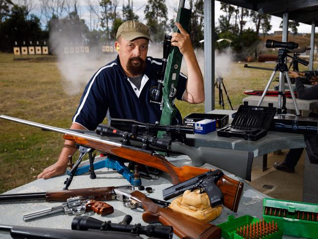 Tasmanian sporting shooter Andrew Judd with part of his collection of guns at the Blue Hills Sporting Shooters Club at Copping in Southern Tasmania. Picture: Peter Mathew