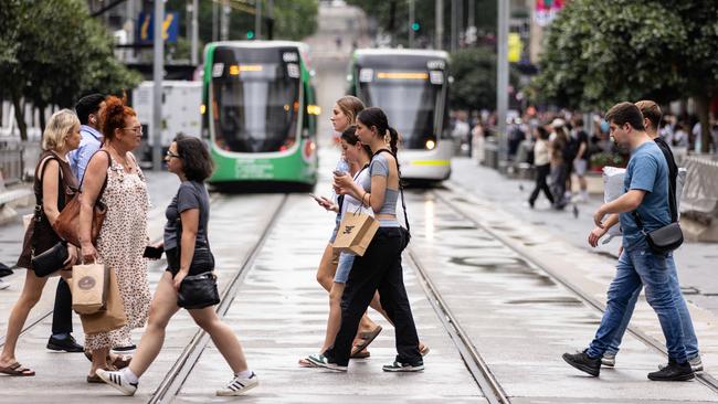 MELBOURNE, AUSTRALIA - NCA NewsWire Photos - 13 DECEMBER, 2023: People carry shopping bags while walking along Bourke Street Mall in Melbourne. Picture: NCA NewsWire / Diego Fedele