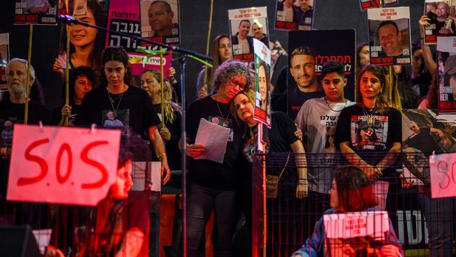 Released hostages Aviva Siegel (centre left) hugs Raz Ben Amiat at a Tel Aviv rally in 2024. Picture: Getty