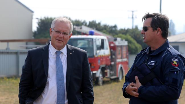 Mr Morrison speaks to air attack supervisor Wesley Bruce from the Queensland Fire Service. Picture: LUKE BOWDEN