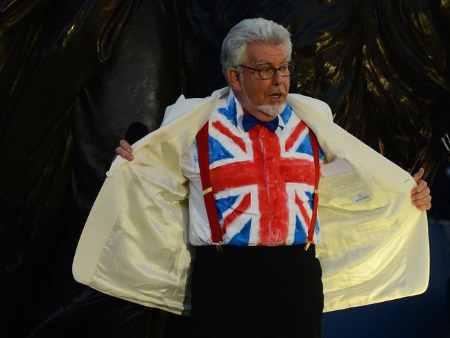 Rolf Harris shows off his Union Jack shirt on stage during the Queen’s Diamond Jubilee Concert at Buckingham Palace in 2012. Picture: AFP