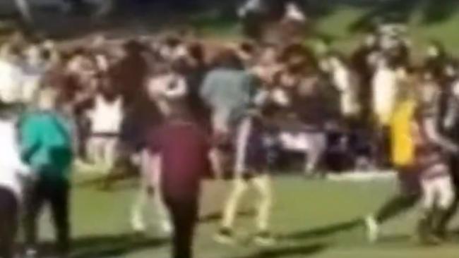 A screen grab from the video of a brawl between spectators and players at the end of the South Australian Rugby League grand final at Mitchell Park. Picture: Nine News