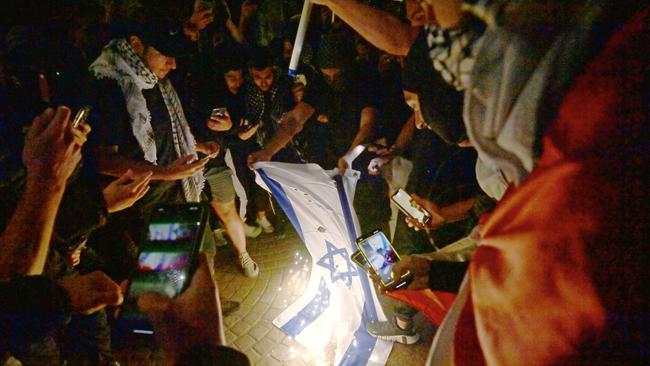 Demonstrators at a Free Palestine rally burn the Israeli flag on the forecourt of the Sydney Opera House. The persistence and virulence of anti-Semitism across centuries and cultures defies rational explanation. Picture: NCA NewsWire / Jeremy Piper